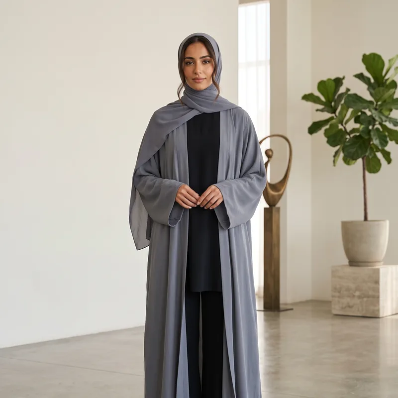 An open-front abaya in slate, worn over black